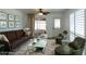 Inviting living room with comfortable seating, textured rug, and a bright sunny area at 6272 Sooner St, North Port, FL 34287