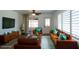 Cozy living room boasts a plush sofa, entertainment center, and bright accents at 6272 Sooner St, North Port, FL 34287
