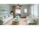 Bright living room features a seating area, stylish decor, and ample natural light at 6272 Sooner St, North Port, FL 34287
