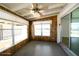 Cozy sunroom with natural wood paneling, ceiling fan, bright lighting, and sliding glass doors at 6272 Sooner St, North Port, FL 34287