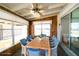 Bright sunroom featuring dining table with seating, natural lighting and paneled walls at 6272 Sooner St, North Port, FL 34287