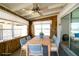Sunroom featuring dining table with seating, natural lighting, a ceiling fan, and sliding glass doors at 6272 Sooner St, North Port, FL 34287