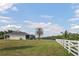 Waterfront backyard featuring an enclosed lanai and expansive lawn at 7200 Riverside Dr, Punta Gorda, FL 33982