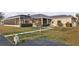 Backyard featuring an enclosed lanai, concrete pathway, and well-manicured lawn at 7200 Riverside Dr, Punta Gorda, FL 33982