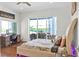 Relax in this bedroom featuring water views, a writing desk and plush bedding at 7200 Riverside Dr, Punta Gorda, FL 33982