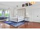 Bright bedroom with a canopy bed, modern lamps, blue rug, and waterfront views at 7200 Riverside Dr, Punta Gorda, FL 33982