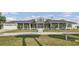 Spacious ranch-style home with a metal roof, large screened porch, and a well-manicured front lawn at 7200 Riverside Dr, Punta Gorda, FL 33982