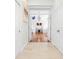 Hallway leading to a brightly lit room with hardwood floors and neutral décor at 7200 Riverside Dr, Punta Gorda, FL 33982