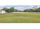 Sprawling lot surrounded by a white fence offering ample space and privacy at 7200 Riverside Dr, Punta Gorda, FL 33982