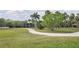 Lush, expansive lot featuring a winding driveway and mature palm trees at 7200 Riverside Dr, Punta Gorda, FL 33982