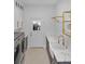 Well-appointed laundry room with modern appliances, beautiful countertops, farmhouse sink and custom shelving at 7200 Riverside Dr, Punta Gorda, FL 33982