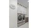 This laundry room offers modern washer and dryer, with upper cabinets for ample storage and convenience at 7200 Riverside Dr, Punta Gorda, FL 33982