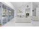 Living room featuring a chandelier, fireplace, modern seating, and expansive windows for a bright, elegant space at 7200 Riverside Dr, Punta Gorda, FL 33982