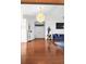 Spacious living room with a statement chandelier, hardwood floors and a stylish blue sofa at 7200 Riverside Dr, Punta Gorda, FL 33982