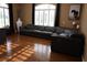 Spacious living room with a large leather sectional sofa, lots of natural light and rich hardwood floors at 7200 Riverside Dr, Punta Gorda, FL 33982