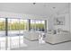 Bright, modern living room with floor-to-ceiling windows and waterfront views at 7200 Riverside Dr, Punta Gorda, FL 33982