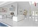 Open living area with white tile flooring, fireplace, and large windows for natural light and views at 7200 Riverside Dr, Punta Gorda, FL 33982