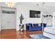 Bedroom-adjacent living area with a plush blue couch, TV and stylish accents at 7200 Riverside Dr, Punta Gorda, FL 33982