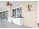This covered patio features an outdoor kitchen with a sink, cabinetry and a dishwasher, perfect for entertaining at 7200 Riverside Dr, Punta Gorda, FL 33982