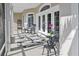 Covered patio with rocking chairs, area rug, table and chairs offers a cozy outdoor living space at 7200 Riverside Dr, Punta Gorda, FL 33982