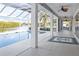 Spacious covered patio with a pool and water view, an outdoor seating area, and multiple ceiling fans at 7200 Riverside Dr, Punta Gorda, FL 33982