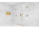A Luxurious shower with rain heads and modern gold fixtures against pristine marble styled tiles at 7200 Riverside Dr, Punta Gorda, FL 33982