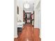 Luxurious walk-in closet with custom shelving, drawers and hardwood floors under a glamorous light fixture at 7200 Riverside Dr, Punta Gorda, FL 33982