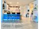 Spacious eat-in kitchen area with blue island, modern seating and bright white cabinetry at 7232 W Lenox Cir, Punta Gorda, FL 33950