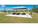 Community picnic area with tables and BBQ grills near a pond for outdoor enjoyment at 7232 W Lenox Cir, Punta Gorda, FL 33950