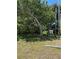 Grassy front yard with mature trees offering lots of shade at 805 S Green Cir, Venice, FL 34285
