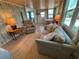 Cozy living room with wood-paneled walls and comfortable seating at 805 S Green Cir, Venice, FL 34285