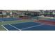 Active community featuring multiple pickleball courts and shaded seating areas for relaxation and socializing at 805 S Green Cir, Venice, FL 34285