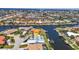 Aerial view of canal-front home with a private pool and boat dock, nestled in a neighborhood at 810 Napoli Ln, Punta Gorda, FL 33950
