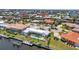 Aerial view of a luxury canal-front property with a boat dock and a sparkling swimming pool at 810 Napoli Ln, Punta Gorda, FL 33950