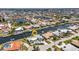 Aerial view of waterfront home in a residential neighborhood with canals and luxurious homes at 810 Napoli Ln, Punta Gorda, FL 33950