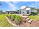 Spacious backyard with a pool, patio, and lush greenery, perfect for outdoor living and entertaining at 810 Napoli Ln, Punta Gorda, FL 33950