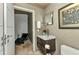 Contemporary bathroom with a floating vanity, unique artwork, and access to a relaxation area at 810 Napoli Ln, Punta Gorda, FL 33950
