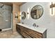 Well-lit bathroom featuring double vanity with wood cabinets and decorative mirrors at 810 Napoli Ln, Punta Gorda, FL 33950
