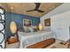 Bedroom with a large bed, ceiling fan, and hanging lights at 810 Napoli Ln, Punta Gorda, FL 33950
