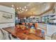 Open dining area features wood-clad ceilings, modern decor, and a spacious layout at 810 Napoli Ln, Punta Gorda, FL 33950