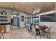 Stylish dining room with wood ceilings, water views, and designer lighting at 810 Napoli Ln, Punta Gorda, FL 33950