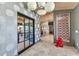 Elegant entry with a gray dandelion wallpaper, views to the dining room, and unique art at 810 Napoli Ln, Punta Gorda, FL 33950