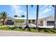 Charming home featuring modern landscaping, a sleek white exterior, and a metal roof at 810 Napoli Ln, Punta Gorda, FL 33950