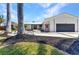 Modern single-story home with grey roof, black mulch landscaping, and a large garage door at 810 Napoli Ln, Punta Gorda, FL 33950