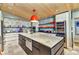 Bright kitchen with a large island, wine fridge, and unique face-themed wallpaper at 810 Napoli Ln, Punta Gorda, FL 33950