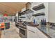 Modern kitchen with a stainless steel oven and range, granite counters, and artful backsplash at 810 Napoli Ln, Punta Gorda, FL 33950
