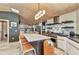 Gourmet kitchen featuring a marble island, stainless steel appliances, and unique overhead lighting at 810 Napoli Ln, Punta Gorda, FL 33950