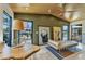 Open living area with travertine floors, a wooden ceiling, and views of the lush outdoor scenery at 810 Napoli Ln, Punta Gorda, FL 33950