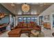 Inviting living room with a large leather couch, wood-paneled ceilings, and water views at 810 Napoli Ln, Punta Gorda, FL 33950