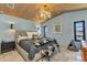 Serene main bedroom with soft blue walls, wood-paneled ceiling, and water view window at 810 Napoli Ln, Punta Gorda, FL 33950